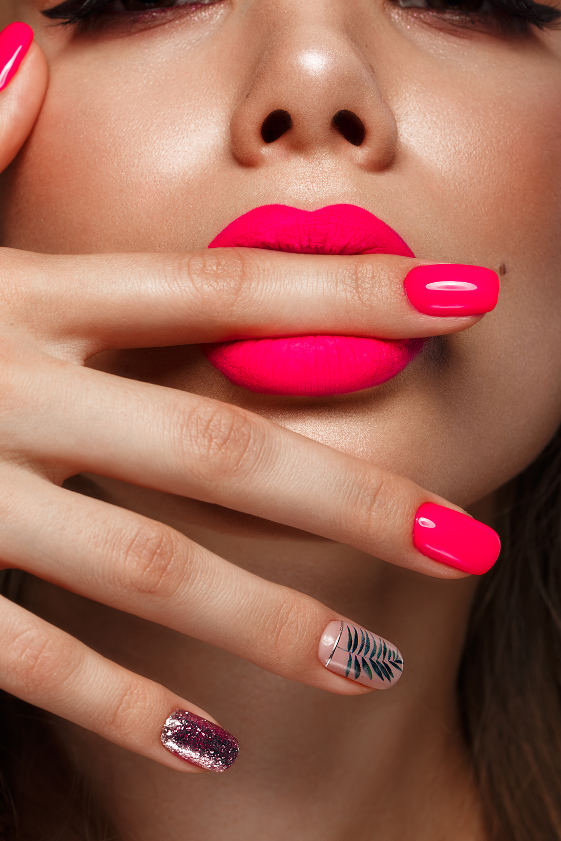 woman with neon pink nails.